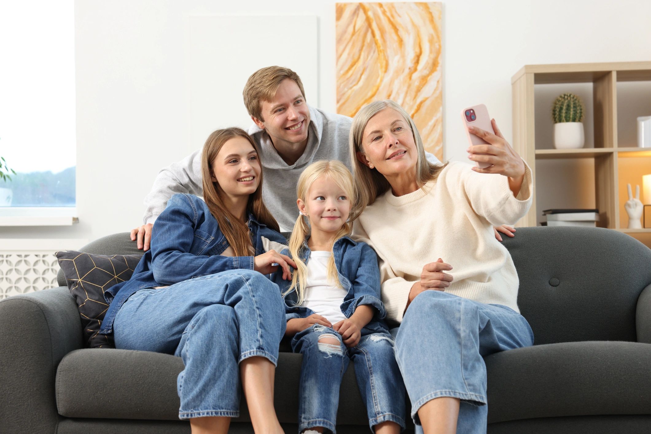 Senior woman taking a family selfie at home